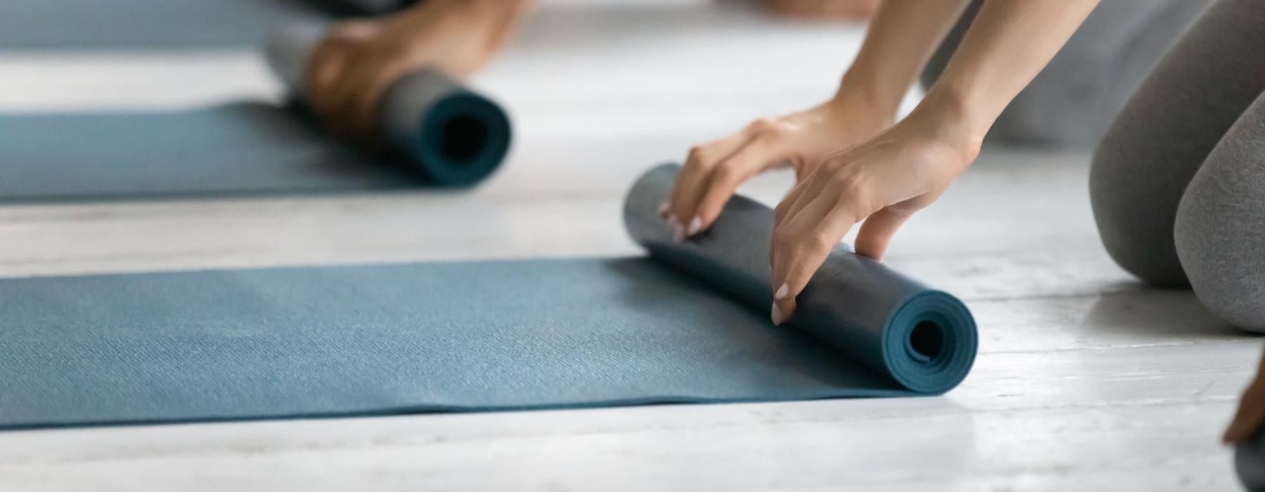 people rolling up yoga mats